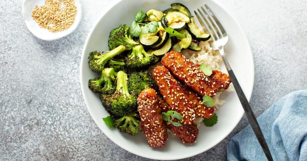Image showcasing a variety of dishes infused with tempeh, including a colorful stir-fry or a nutrient-packed Buddha bowl.